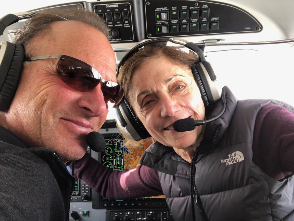 Rob Ross and his wife, Cathie, in the interior of a small plane 